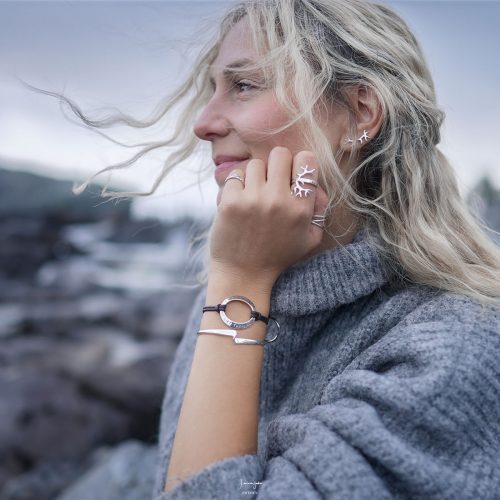 A woman wearing a silver antler ring with reindeer-inspired antlers