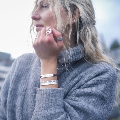 A woman wearing a silver antler ring with reindeer-inspired antlers