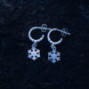 Handcrafted sterling silver snowflake earrings with delicate hoop design.