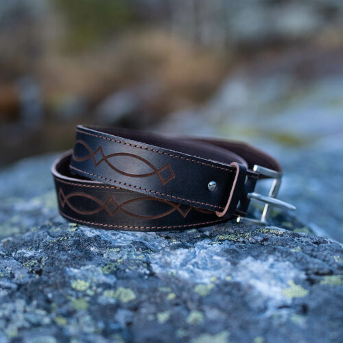 A handcrafted brown leather belt using naturally tanned leather designed with timeless simplicity, natural beauty, and traditional craftsmanship.