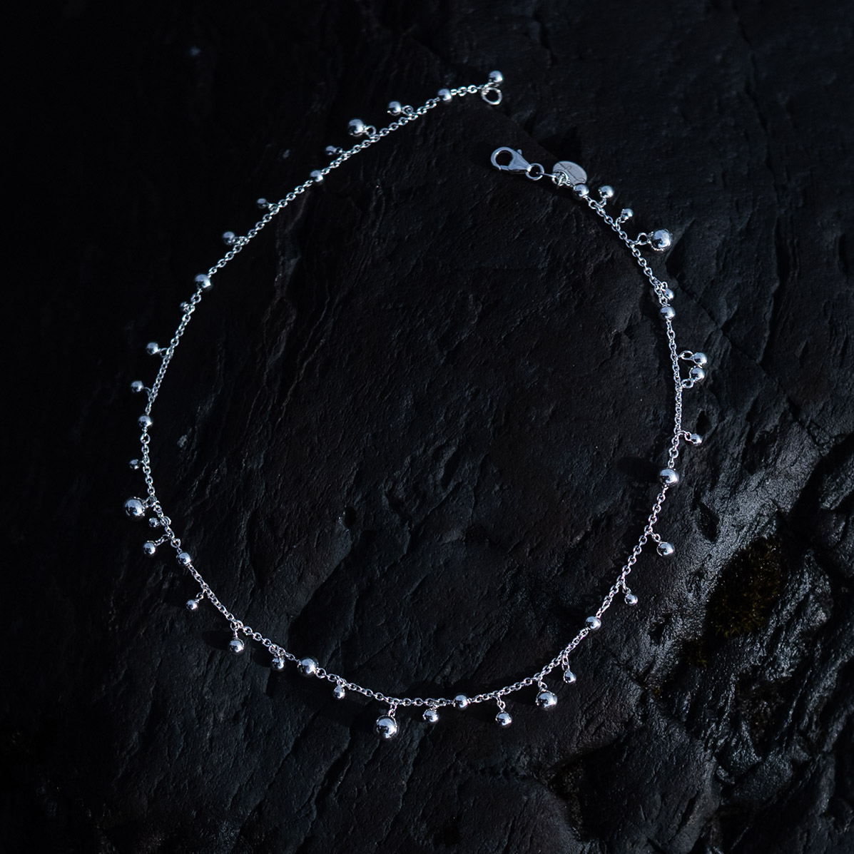 Skir Necklace, a sterling silver bead necklace with polished silver beads in varying sizes on a delicate 925 sterling silver chain.