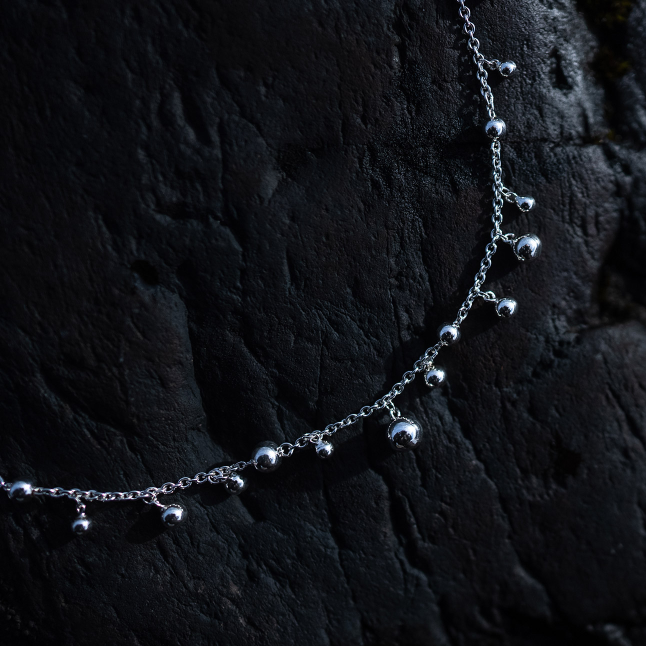 Skir Necklace, a sterling silver bead necklace with polished silver beads in varying sizes on a delicate 925 sterling silver chain.