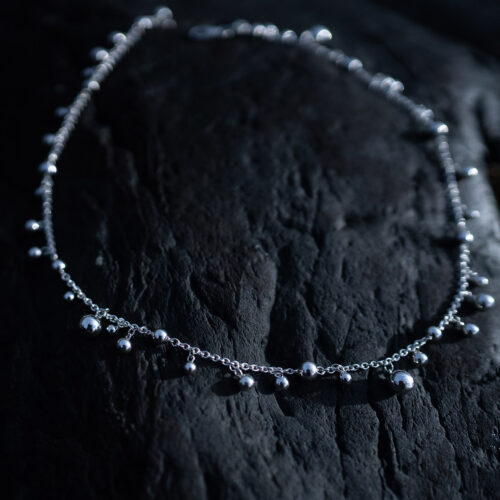 Skir Necklace, a sterling silver bead necklace with polished silver beads in varying sizes on a delicate 925 sterling silver chain.
