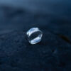 Handcrafted sterling silver water ring with flowing organic curves inspired by waves.
