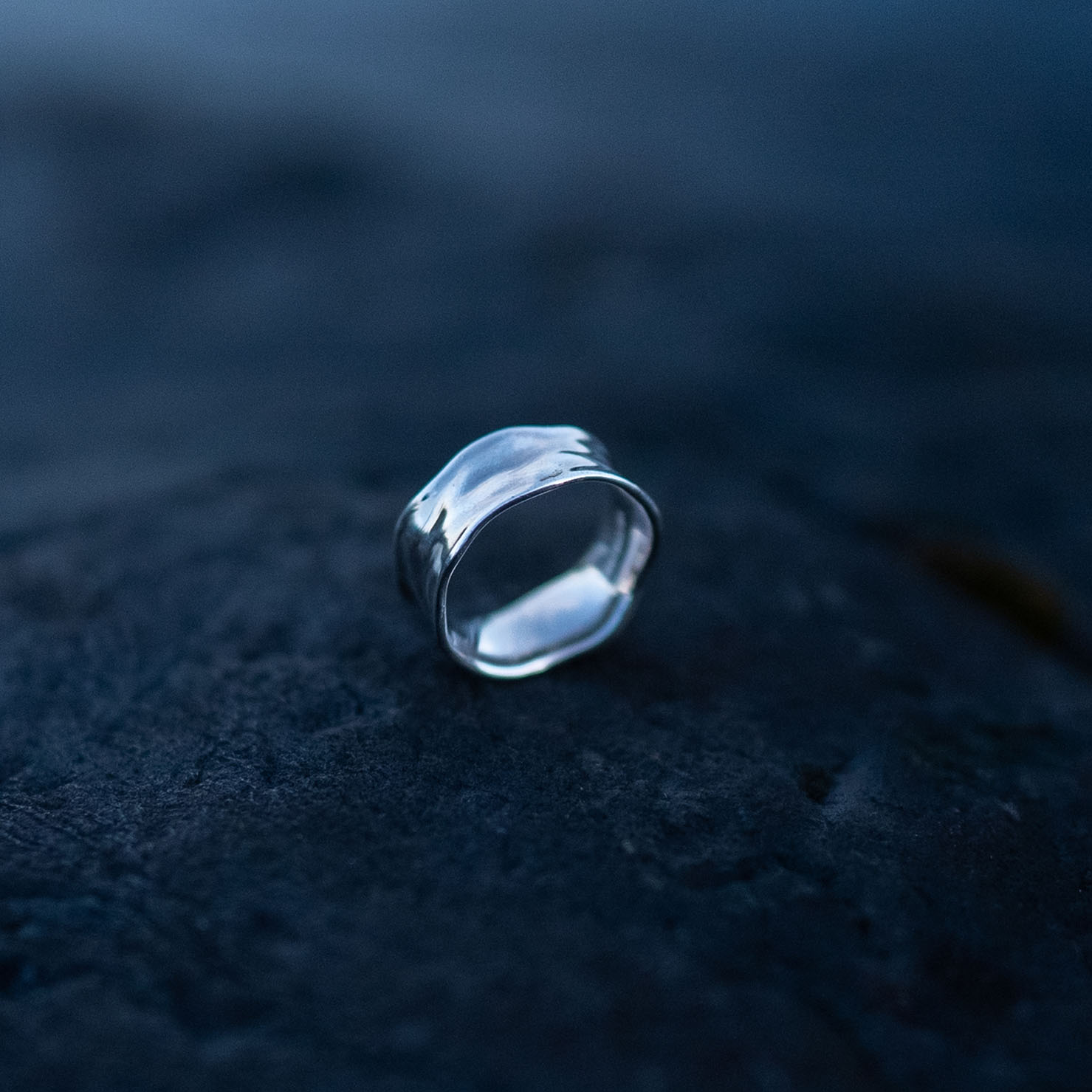 Handcrafted sterling silver water ring with flowing organic curves inspired by waves.