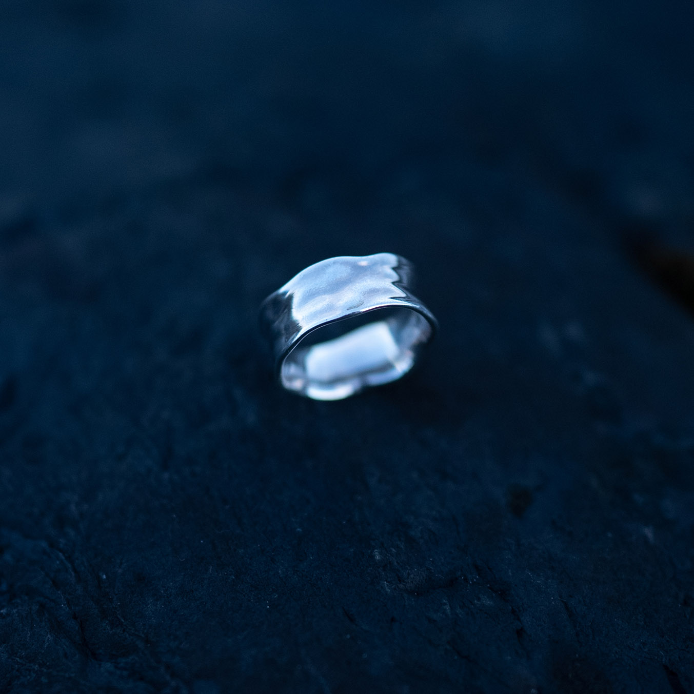 Handcrafted sterling silver water ring with flowing organic curves inspired by waves.