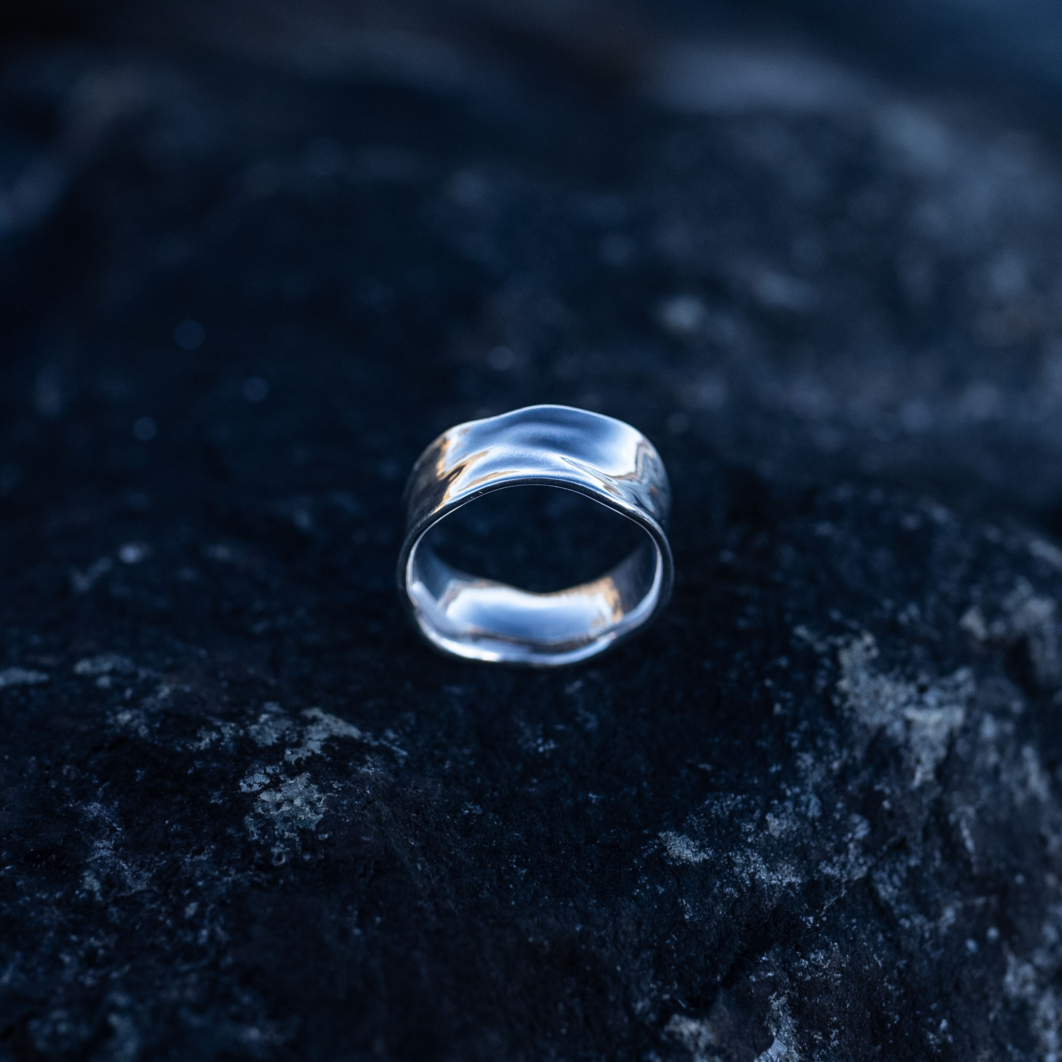 Handcrafted sterling silver water ring with flowing organic curves inspired by waves.