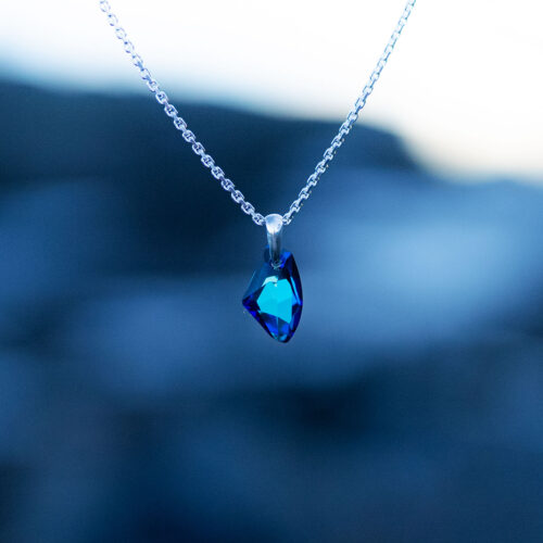 Nebula Necklace with a radiant blue Swarovski crystal pendant on a sterling silver chain, inspired by the beauty of the cosmos and the night sky