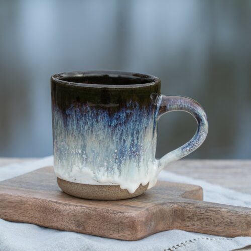 Handmade ceramic mug, "Singing Ice" by Jonna Jinton, featuring an ice-inspired glaze and textured surface inspired by Nordic winter landscapes.